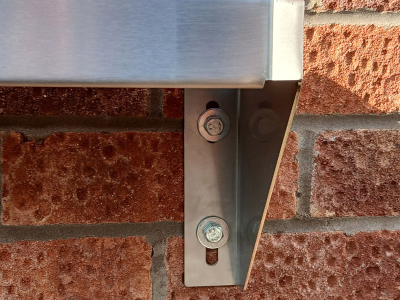 Corner detail of stadium shelf showing adjustable bolt slots
