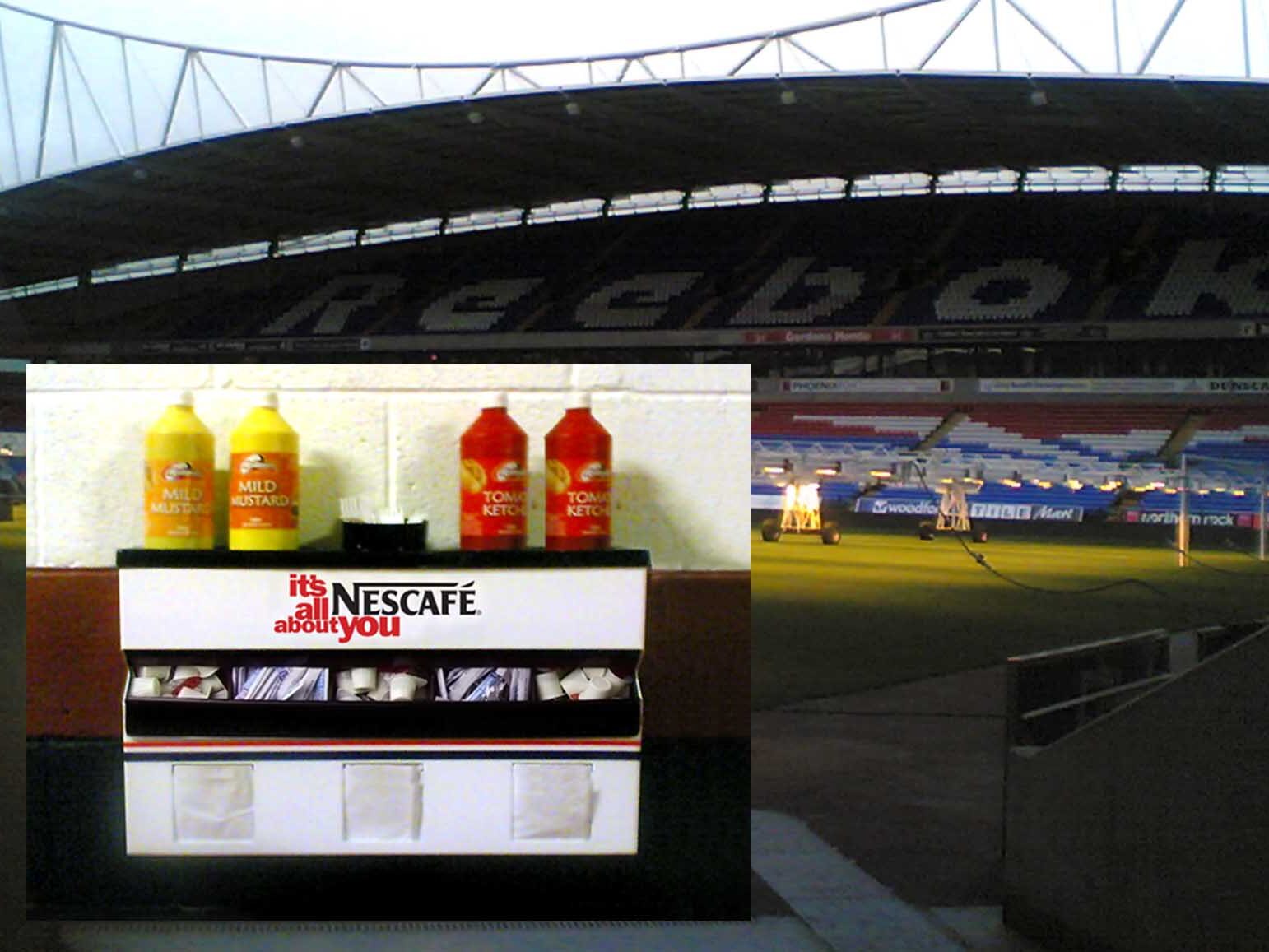 Sauce Station against background of The Reebopk Stadium, Bolton