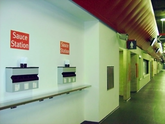 Sauce stations along the Emirates stadium Concourses ( Combined napkin Dispenser , gravity fed sachet dispenser, plus cutlery trays and straws cup)